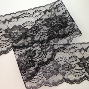 May include: Black lace trim with a floral pattern. The lace is delicate and has a scalloped edge.