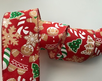 May include: Red Christmas ribbon with a repeating pattern of gingerbread men, snowflakes, candy canes, and Christmas trees. The ribbon has a festive design, perfect for holiday crafts and gift wrapping.