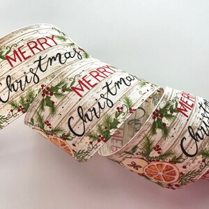 May include: A rolled ribbon with a festive "Merry Christmas" design. The ribbon features a cream-colored background with a wood-grain pattern. It is adorned with illustrations of holly, berries, and orange slices. The words "Merry Christmas" are printed in red and black.