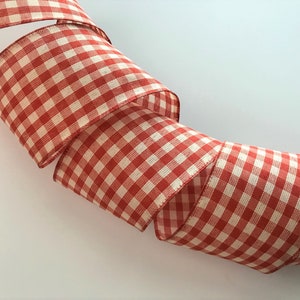 May include: Red and white gingham ribbon, a classic pattern for crafting and decorating.