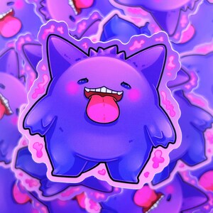 May include: A purple sticker of a cartoon character with a wide grin and a pink tongue. The character has a rounded body, small arms, and a jagged outline. Pink blush is on the cheeks. The sticker has a pink border with heart shapes.