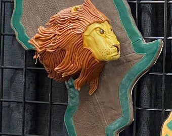 Big Game designer lion head in detailed leatherwork for great wall display.