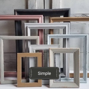 May include: A collection of rectangular picture frames in various colors, including pink, white, gray, and tan. The frames have a distressed, vintage appearance, with the word "Simple" on a label.
