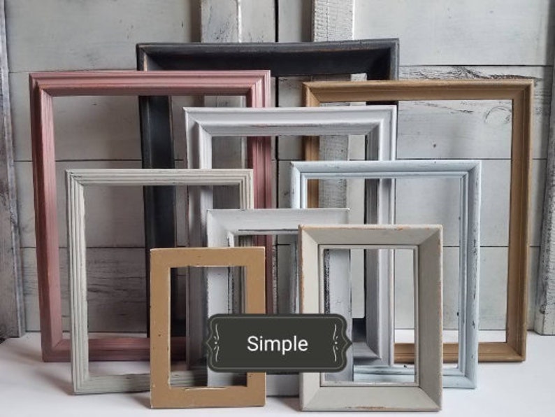 May include: A collection of rectangular picture frames in various colors, including pink, white, gray, and tan. The frames have a distressed, vintage appearance, with the word "Simple" on a label.