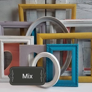 May include: A collection of colorful, distressed wooden picture frames in various shapes and sizes. Frames are painted in shades of teal, yellow, pink, gray, and white. Some frames have a heart-shaped cutout. The word "Mix" is displayed on a black label.