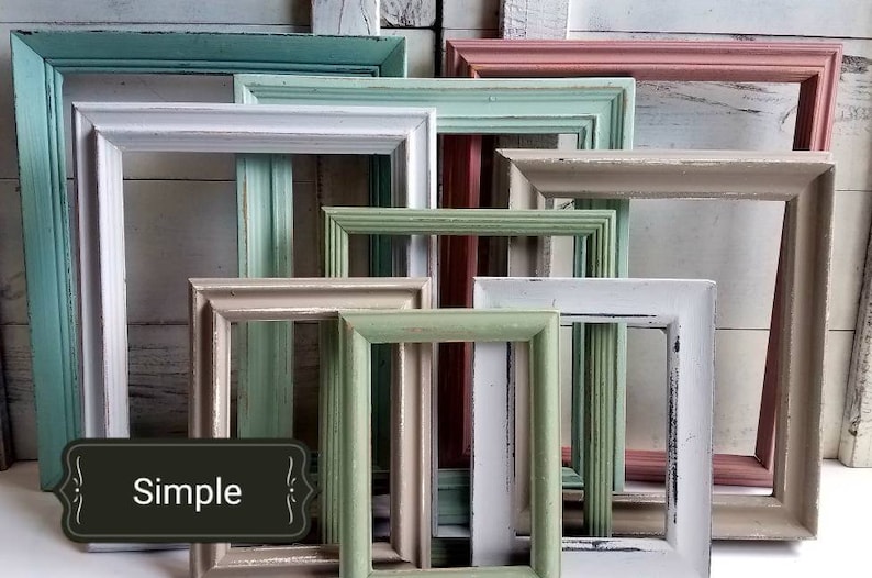 May include: A collection of various sized, rectangular picture frames in a variety of pastel colors, including teal, pink, white, and green. The frames have a distressed, vintage look, with visible wood grain and chipped paint. The word "Simple" is on a black label.