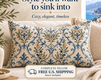 May include: A rectangular throw pillow featuring a cream-colored base with a repeating blue, green, and gold damask-style botanical pattern. The text on the image reads: Style you'll want to sink into, Cozy, elegant, timeless, and THE AMALFI VILLA.