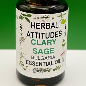 May include: A small brown glass bottle with a white cap and a white label. The label says "Herbal Attitudes Clary Sage Bulgaria Essential Oil".