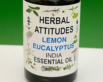May include: A small brown glass bottle with a white cap, labeled "HERBAL ATTITUDES LEMON EUCALYPTUS INDIA ESSENTIAL OIL". The label features a variety of green and colorful floral illustrations.