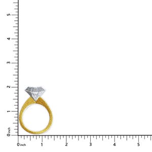 May include: A gold-colored ring with a large, diamond-shaped, silver-colored stone. The ring is embroidered with a textured design. The image includes an inch ruler for scale.