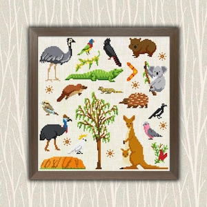 May include: A framed cross-stitch depicting Australian wildlife and flora. The design includes an emu, kangaroo with joey, koala, and a tree, all in a pixelated style. The color palette features browns, greens, and greys.