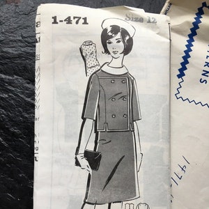 May include: A vintage sewing pattern for a dress and jacket. The pattern is for size 12 and features a black and white illustration of a woman wearing the outfit. The pattern is titled "Take These Steps" and includes instructions for sewing the garment.