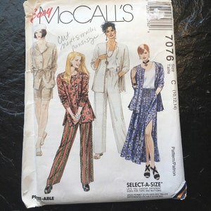 May include: A sewing pattern for a skirt and pants with a floral print. The pattern is from McCall's and is size C (10, 12, 14). The pattern is called "Select-A-Size" and allows you to choose different sizes for the top and bottom.