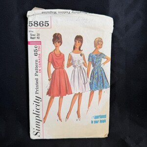 May include: Vintage Simplicity sewing pattern, number 5865, featuring illustrations of three dresses. The pattern is for a Miss size 20 with a bust size of 40 inches. The cover includes the text "Printed Pattern 65c IN CANADA 75c".