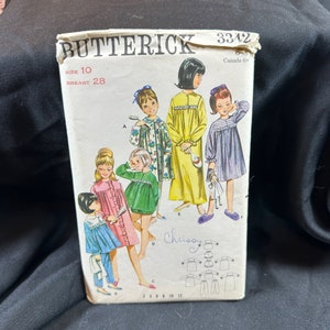 May include: A vintage sewing pattern for girls' nightgowns, featuring four different styles. The pattern is from Butterick, number 3342, and is for size 10 with a 28-inch bust. The pattern includes instructions for making the nightgowns and a diagram of the different pieces.