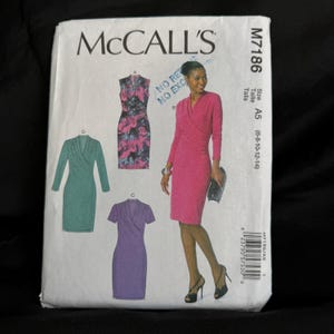May include: A McCall's sewing pattern envelope featuring illustrations of wrap dresses in various colors and styles. The envelope includes the text "McCall's" and pattern number M7186. The size range is A5 (6-8-10-12-14).