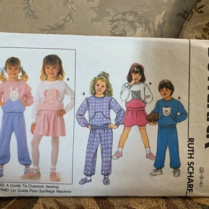 May include: A sewing pattern for children's clothing, featuring five different outfits. The pattern is from Butterick and is designed by Ruth Scharf. The pattern is for sizes 2-3-4.