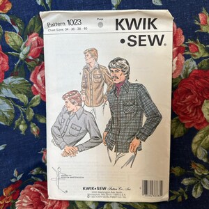 May include: A vintage Kwik Sew pattern packet, Pattern 1023, with illustrations of men's shirts. The packet shows chest sizes 86, 91, 97, and 102 cm. The design includes the Kwik Sew logo and the designer's name, Kerstin Martensson.