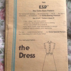 May include: A vintage Simplicity sewing pattern for a dress, pattern number 5369. The pattern is for the "Extra Sure Pattern" (E.S.P.) and includes instructions for sewing a dress with a collared neckline and short sleeves. The pattern is printed on a brown paper background with blue and white accents.