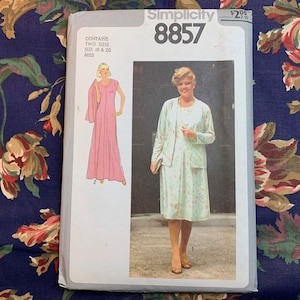 May include: Simplicity sewing pattern number 8857 for a dress and jacket. The pattern includes two sizes, 18 and 20, for misses. The image shows a model wearing a pink dress with a matching jacket and a second model wearing a green and white floral dress with a white jacket.
