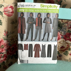 May include: A sewing pattern envelope with the number 4789 and the text "Simplicity easy-to-sew wardrobe elements" printed on the front. The envelope shows a model wearing a red jacket, black pants, a red vest, a gray dress, and a black dress.
