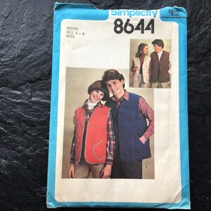 May include: Simplicity sewing pattern number 8644 for a vest. The pattern is for petite sizes 6-8 and miss sizes. The pattern shows two people wearing vests, one in red and one in blue.