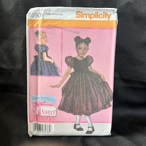 May include: Simplicity sewing pattern 4901 for a girl's dress. The pattern includes two dress styles, one with puffed sleeves and a full skirt, and one with a fitted bodice and a full skirt. The pattern is for sizes HH 3, 4, 5, and 6. The pattern is labeled "Daisy Kingdom Sweet Memories".