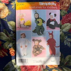 May include: Simplicity pattern for toddler costumes. The pattern includes instructions for making six different costumes: an elephant, a dinosaur, a panda, an angel, a monkey, and a devil. The pattern size is A 1/2, 1, 2, 3, 4.