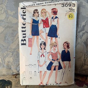 Pode incluir: Padrão de costura vintage para um vestido de menina com colarinho de marinheiro. O padrão é da Butterick e é o número 3093. O padrão é para os tamanhos 8, 10, 12 e 14.