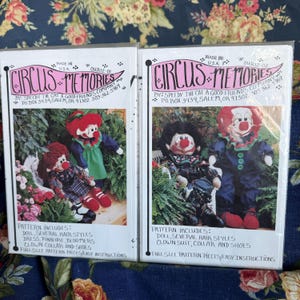 May include: Two sewing pattern packets titled Circus Memories by Speedy the Cat A Good Friend's Company. Each packet features a photograph of a clown doll with red hair and a red nose, including instructions for doll, hair, clothing, and shoes.