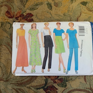 May include: A Butterick 5044 sewing pattern envelope featuring illustrations of five different garment variations including dresses, tunics, and trousers in various colours like yellow, orange, green, black, white, and blue with the text Minnesota Fabrics.