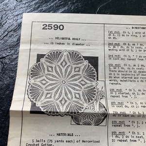 May include: A crochet doily pattern with instructions for a 15-inch doily. The pattern is called "Delightful Doily" and is numbered 2590. The instructions include the materials needed, which are 5 balls of mercerized crochet cotton, each 75 yards long.