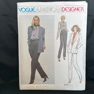 May include: Vogue American Designer sewing pattern number 2076 by John Anthony. The pattern features two women wearing a blazer and pants.