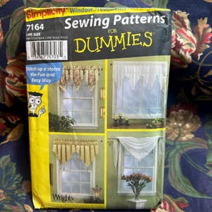 May include: A Simplicity sewing pattern for window treatments, featuring four different curtain styles. The package has a yellow and black design with the text "Sewing Patterns for Dummies" and "Stitch up a storm the Fun and Easy Way".