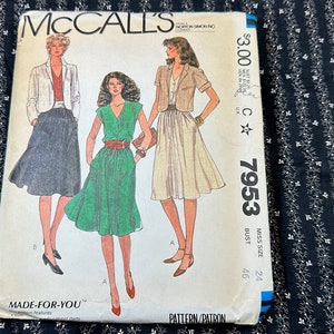 May include: Vintage McCall's sewing pattern for a dress and skirt. The pattern number is 7953 and the size is Miss Size 24, Bust 46. The pattern features three different styles of dresses and skirts, all with a vintage 1980s aesthetic.