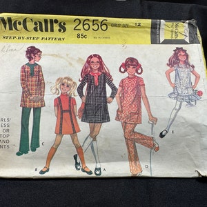 May include: A vintage sewing pattern for girls' clothing. The pattern is for a dress or top and pants. The pattern is from McCall's and is number 2656. The pattern is for size 12 and costs 85 cents.