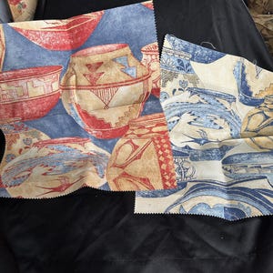 May include: Two fabric swatches with a Southwestern pottery design. The fabric features red, tan, and blue pottery designs on a blue background. The pottery has geometric patterns and shapes. The fabric is likely for home decor or craft projects.