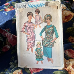 May include: Vintage sewing pattern for a sleeveless apron with pockets. The pattern is for sizes 6809 and includes instructions for making an apron from vinyl-coated fabric.