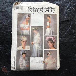 May include: Simplicity sewing pattern number 8509 for a wedding veil. The pattern shows six different styles of veils, including a birdcage veil, a cathedral veil, and a blusher veil.