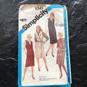 May include: Simplicity sewing pattern number 6541 for a dress with a vest. The pattern includes instructions on how to work with plaids. The pattern is for size 12, miss.