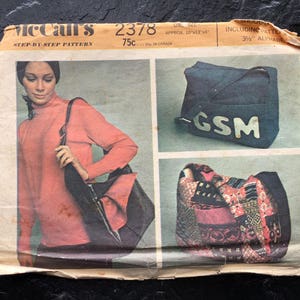 May include: A vintage McCall's sewing pattern for a bag. The pattern is for a tote bag with a GSM logo and a smaller patchwork bag. The pattern is from 1970s and is in good condition.