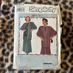 May include: Simplicity sewing pattern number 9414 for a long cardigan with a skirt. The pattern includes two different styles, one in teal and one in burgundy. The pattern is suitable for use with an overlock or serger machine.