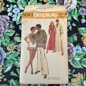 May include: Simplicity sewing pattern number 5043 for a dress and a shirt. The pattern is for a size 16, bust 38 inches. The dress is red and the shirt is green with a heart design. The pattern is $1.00.