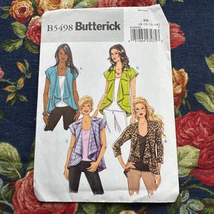 May include: A sewing pattern for a cardigan with four different styles. The pattern is from Butterick and is for sizes 8-10-12-14. The pattern shows four different models wearing the cardigan in different colors and styles.