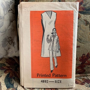 May include: A vintage sewing pattern for a dress and jacket. The pattern is printed on a white paper with a red background. The pattern number is 4892.