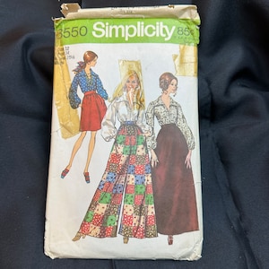 May include: Vintage Simplicity sewing pattern number 3550 for women's trousers and skirt. The pattern features three women wearing different styles of trousers and skirts. The pattern is printed on a white background with green and black text.