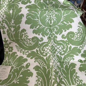 May include: Green and white damask fabric with a floral pattern. The fabric has a subtle sheen and a soft texture.