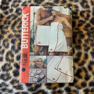 May include: A vintage sewing pattern for a pair of white bathrobes with red trim. The pattern is called "Butterick 206" and costs $2.50. The pattern is for a craft project.