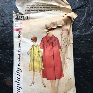 May include: Vintage Simplicity sewing pattern number 4214 for a dress. The pattern is for size 10, bust 31 inches. The pattern includes instructions for making a red dress with a bow and a yellow dress with a collar.