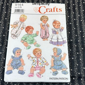 May include: Simplicity Crafts sewing pattern number 9144 for making doll clothes. The pattern includes instructions for making six different outfits for a large doll. The outfits include a sleeper, a dress, a jumpsuit, a jacket, and two more dresses.